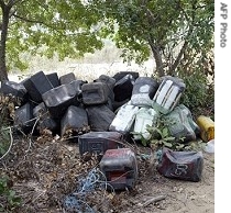 A picture shows dozens of jerry cans used for stealing fuel abandoned at the scene of the oil blast at Abagbo village in Lagos, 26 Dec 2007<br />