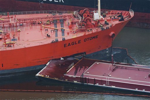       A barge is seen making a large impact gash in the side of the Eagle Otome after two vessels collided causing as much as 450,000 gallons of crude oil to spill, according to the U.S. Coast Guard, on Saturday, Jan. 23, 2010, in Port Arthur, Texas.  Officials contained the spill, but were still assessing the scope and cause. No injuries were reported from the collision.       - Houston Chronicle, Julio Cortez      /AP Photo      